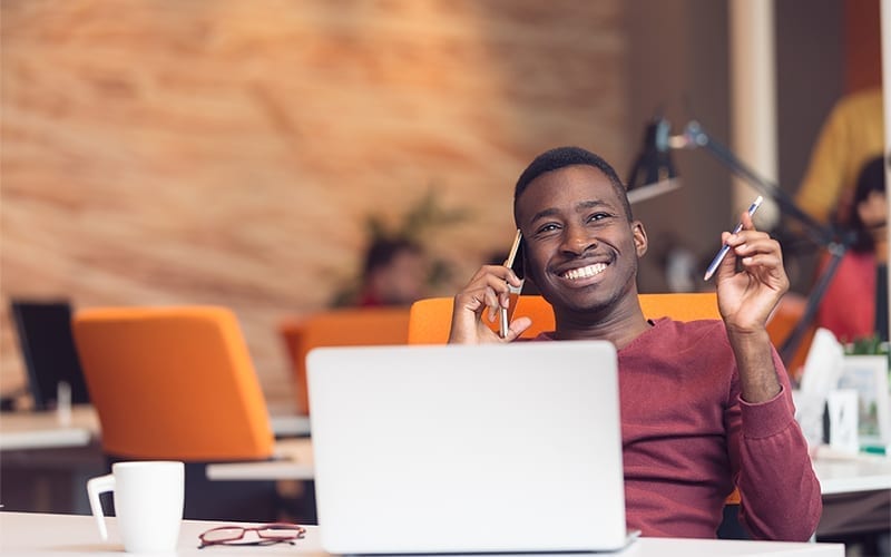 xerox-genuine-supplies-section-1-en Man smiling with computer