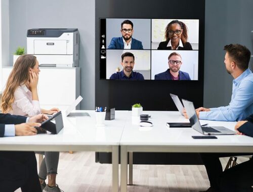 People in a meeting room in front of the Xerox® B410 printer